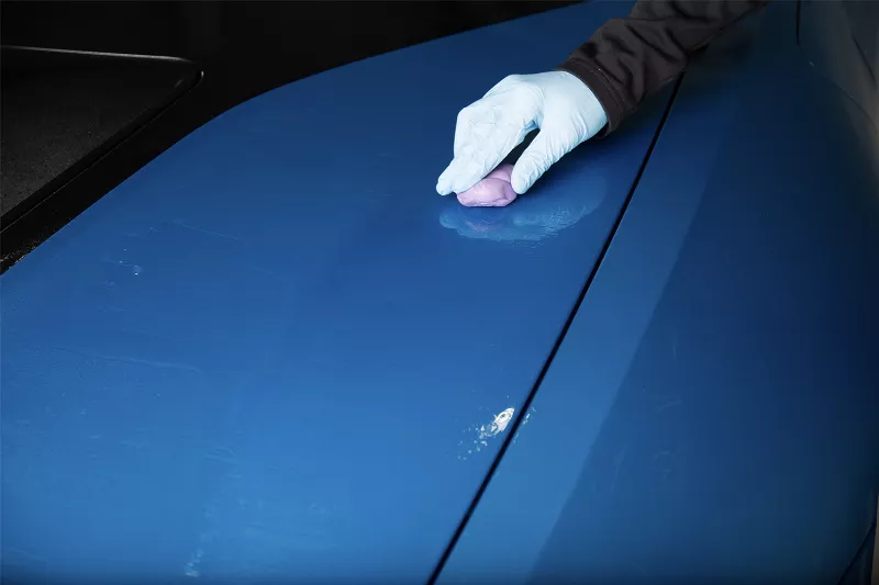 Clay bar treatment removing contaminants from car paint in Miami.