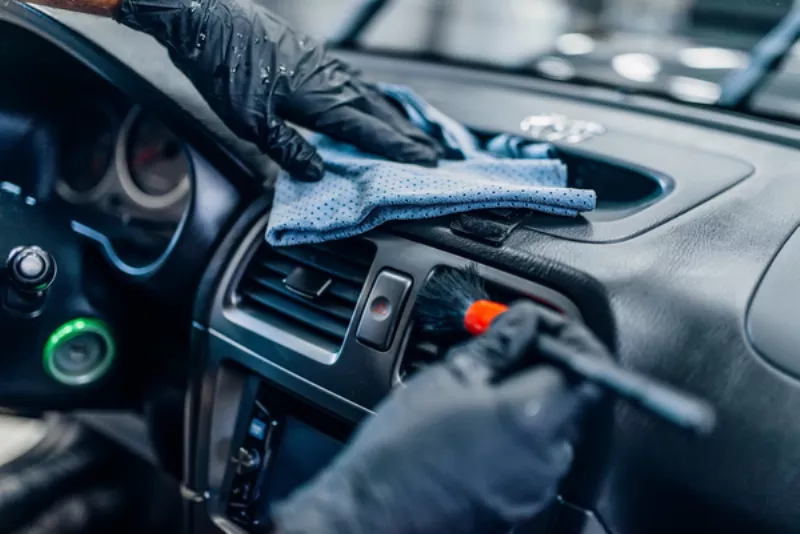 Fresno auto detailing professional cleaning the interior of a vehicle.