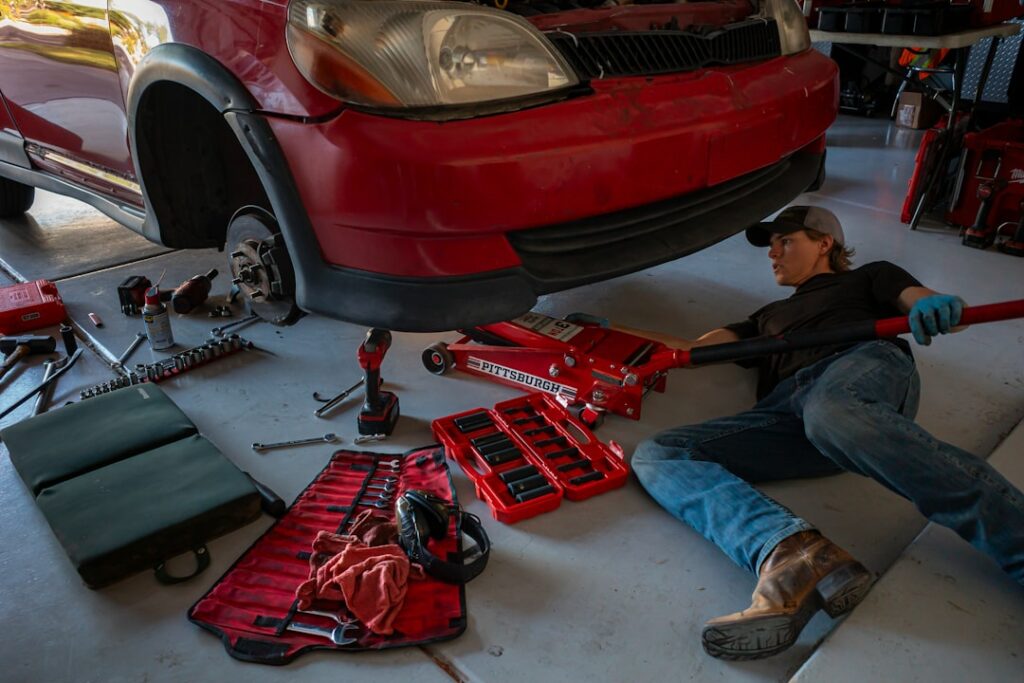 Mechanic working on car suspension in garage