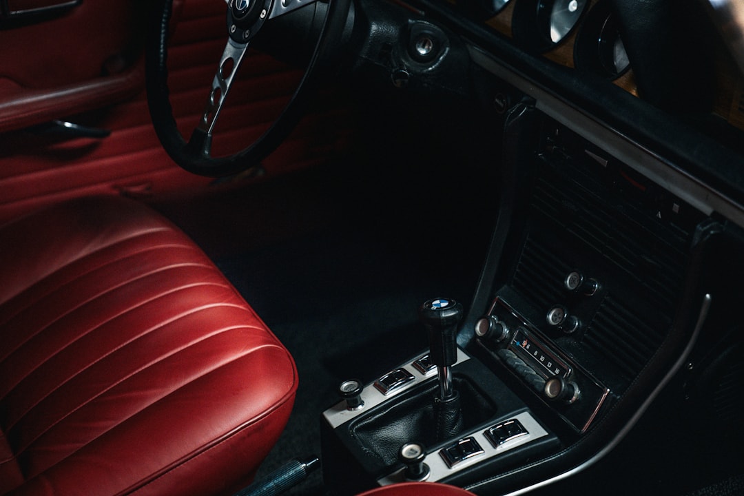 Classic car interior with red leather seats and gear shift