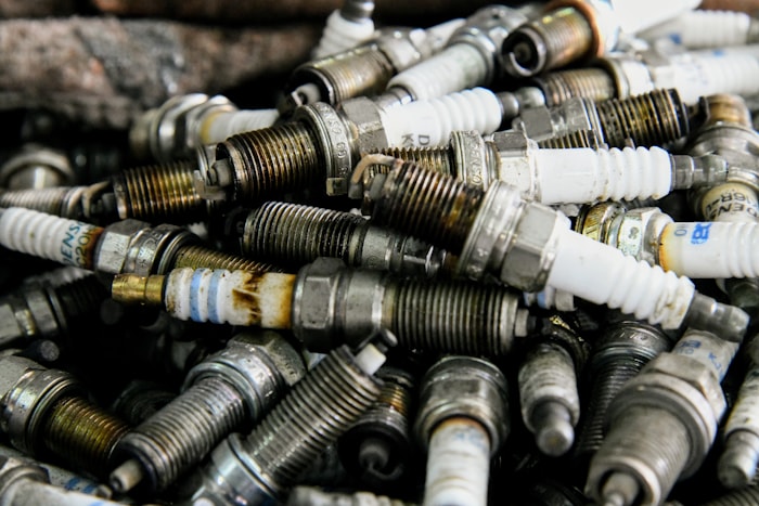 Pile of old spark plugs in a mechanic repair shop